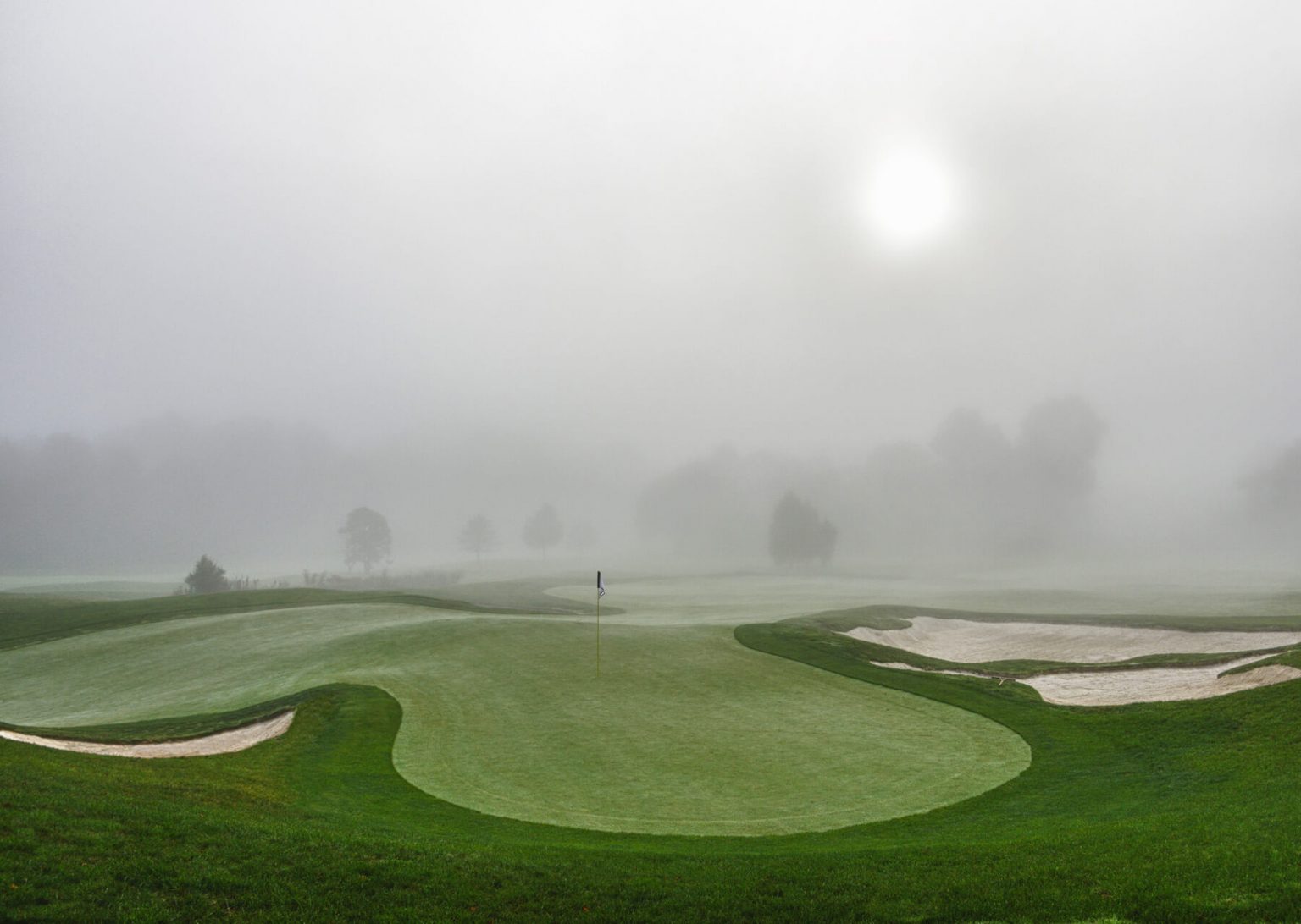 misty sunrise over golf course