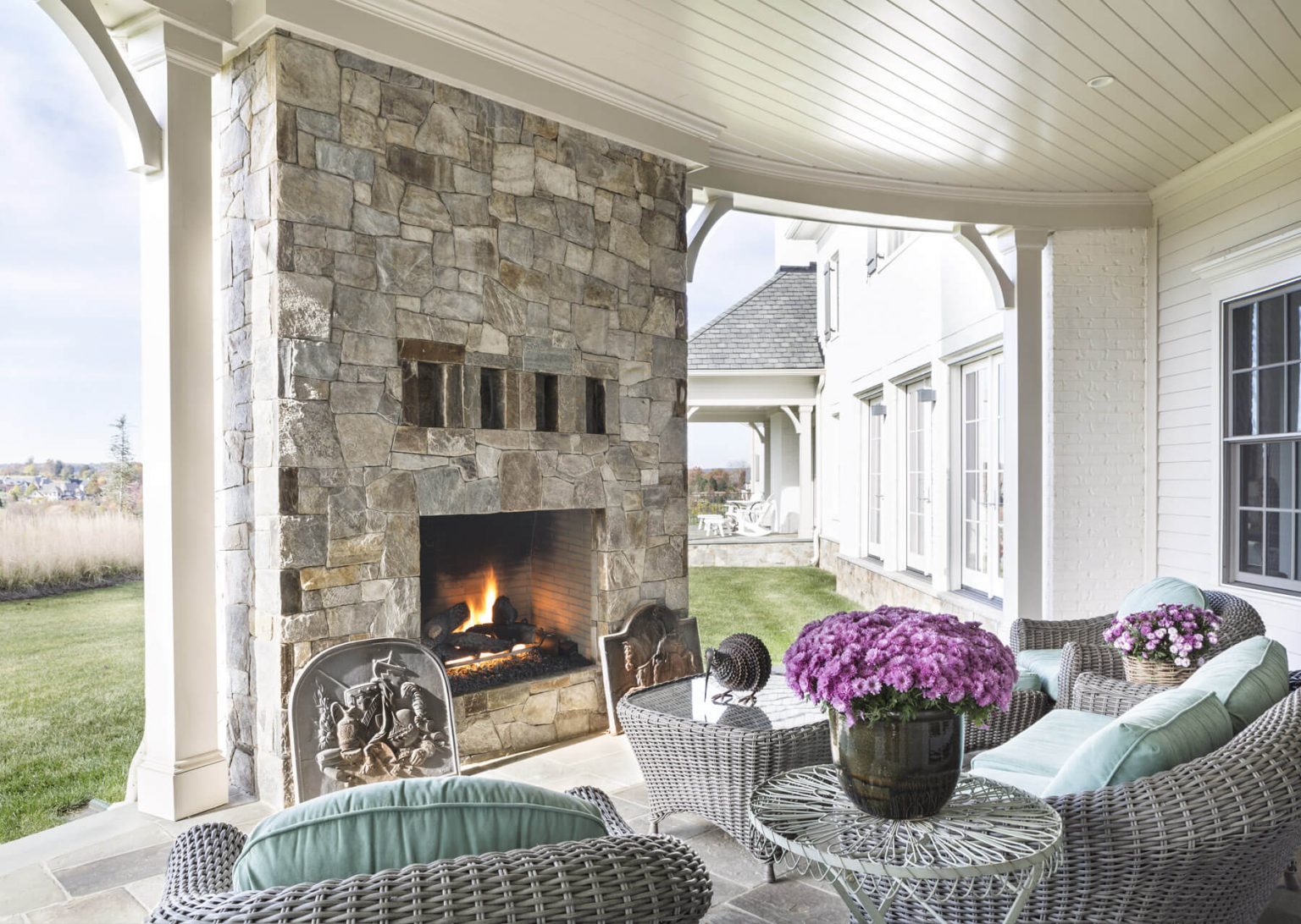 outdoor patio with stonework fireplace