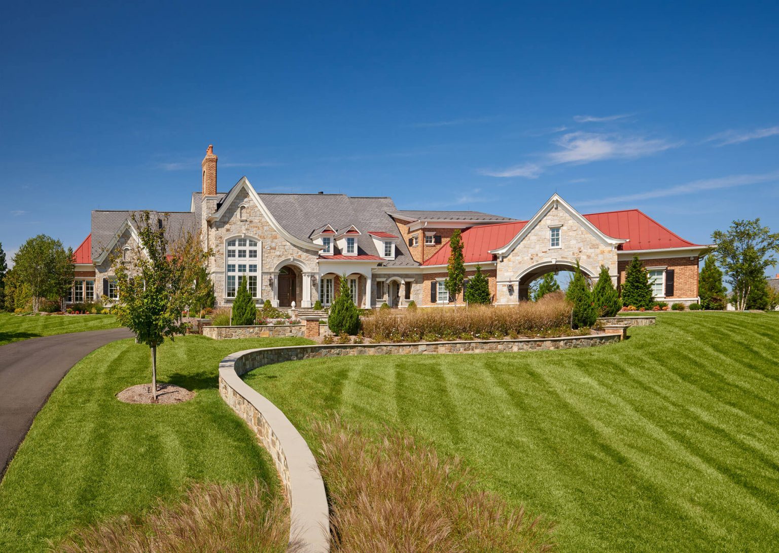 landscaped stonework villa home in gated community