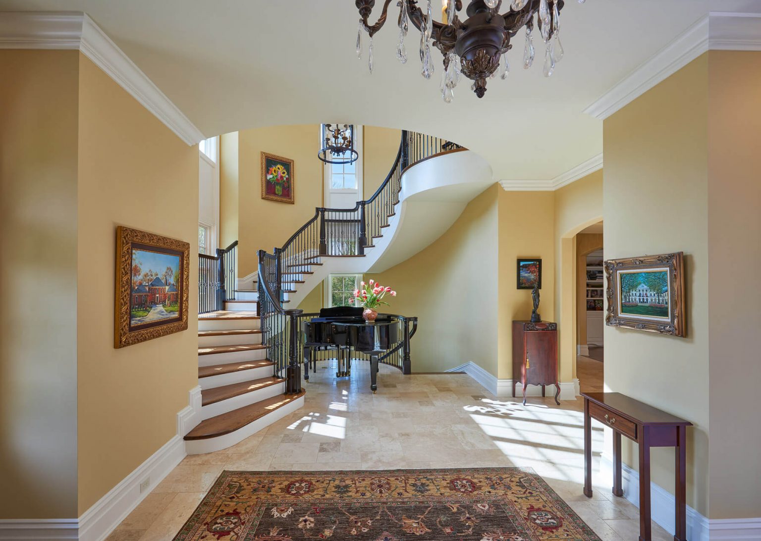 custom home entry with spiral staircase